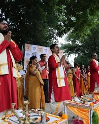 Priests in prayer during outdoor Ganga Aarti ceremony in Canada